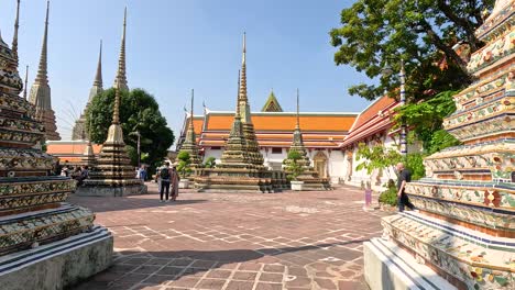 visitors walk around wat pho in bangkok