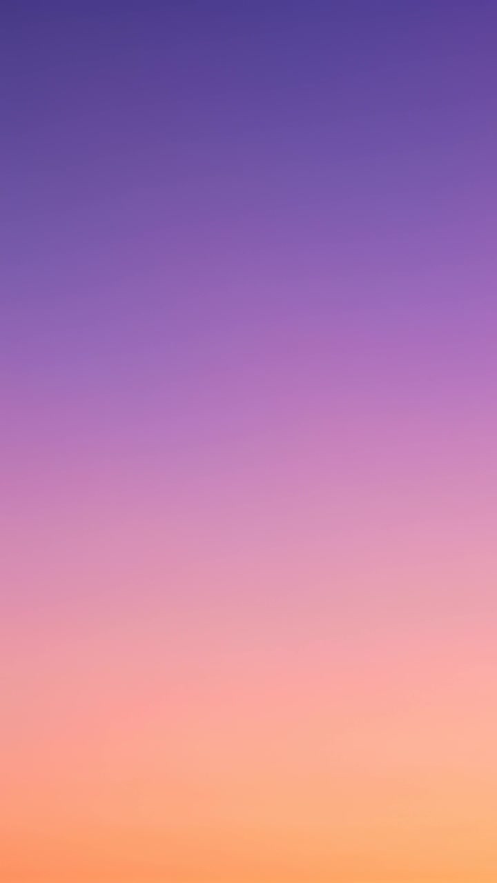 Vertical video: Shifting full-frame gradient at dusk with sun sinking, warm band fading