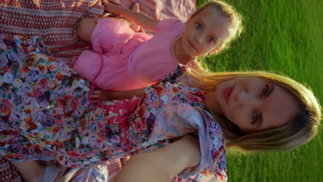 Young-woman-and-girl-speaking-in-city-park.-Family-having-video-call-outdoor.