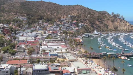 high angle panning wide overview of the town of avalon on catalina island with the opera house in background