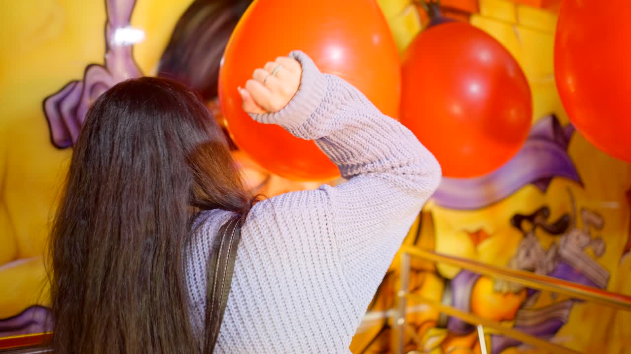 Woman at an amusement park with balloons