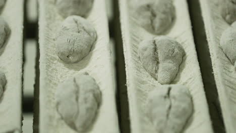 dough of bread during the proofing process in the bakery - the dough is allowed to rest and rise a final time before baking - panning up, slow motion