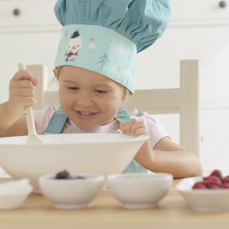 adorable smiling toddler at mixing bowl