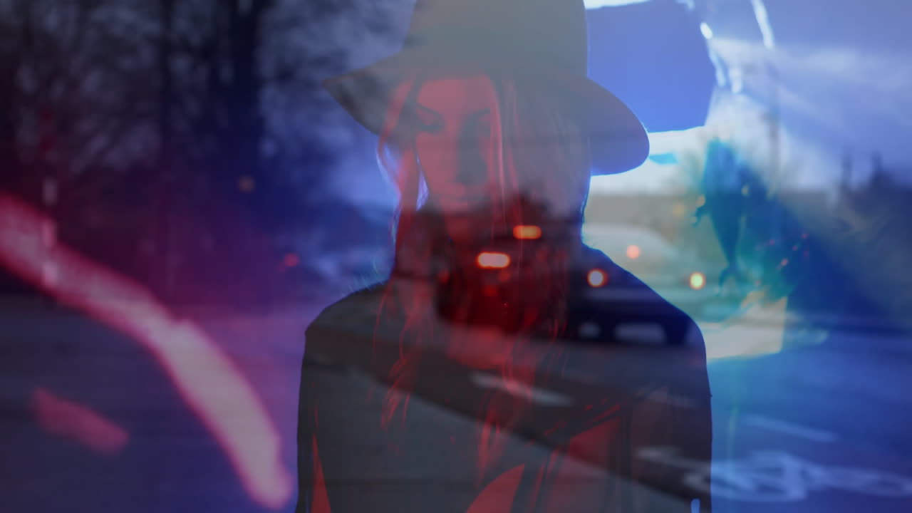woman wearing wide-brimmed hat standing roadside at night, with animated technology light streaks