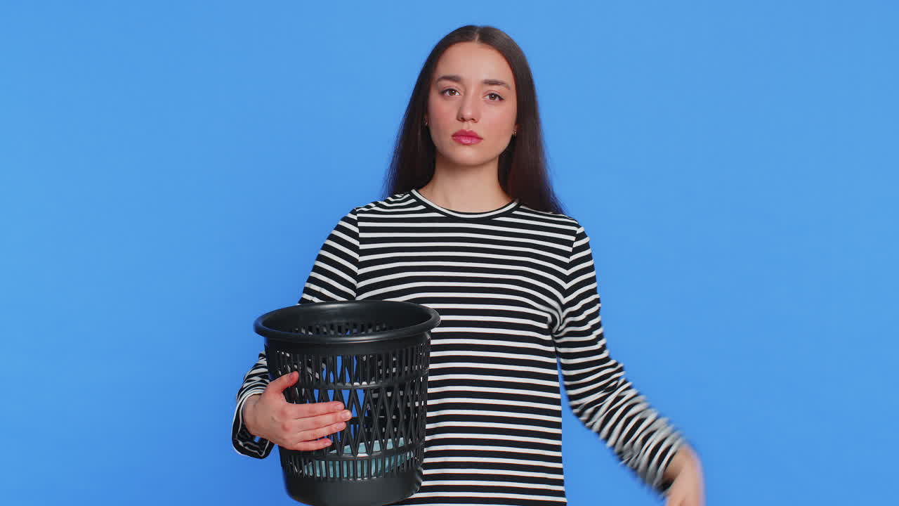 Woman throwing out surgical medical protective mask into bin after pandemic illness sickness ending