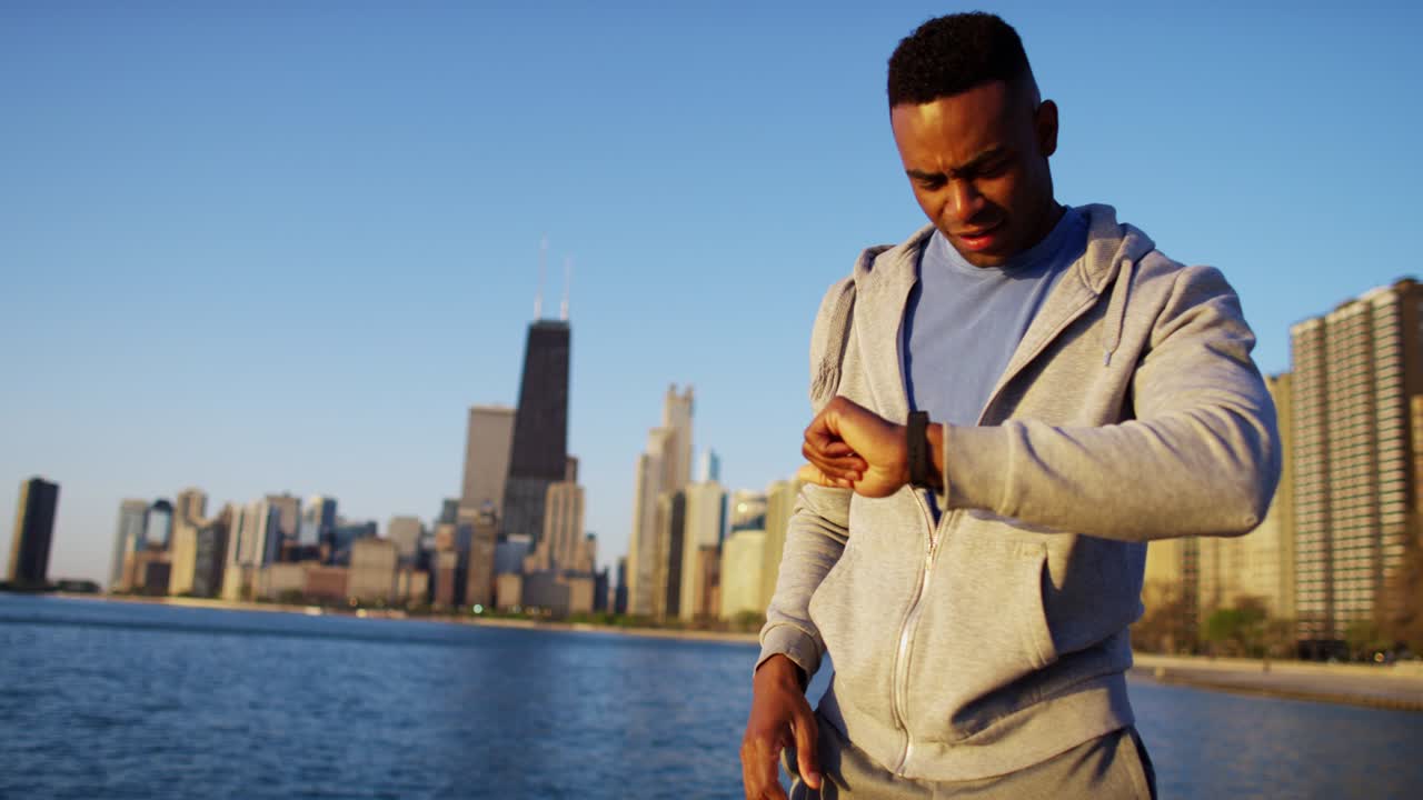 African American male weightloss training wearing smart watch