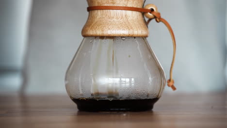Freshly-Brewed-Coffee-Dripping-Inside-A-Pour-Over-Glass-Coffeemaker-On-The-Table