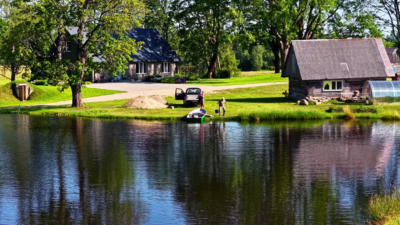 Slow motion shot of a man heading towards banks after halting boat at grassy bank. Day view