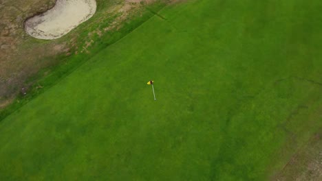 aerial circling over a golf course hole on a green in royston, hertfordshire, england, uk