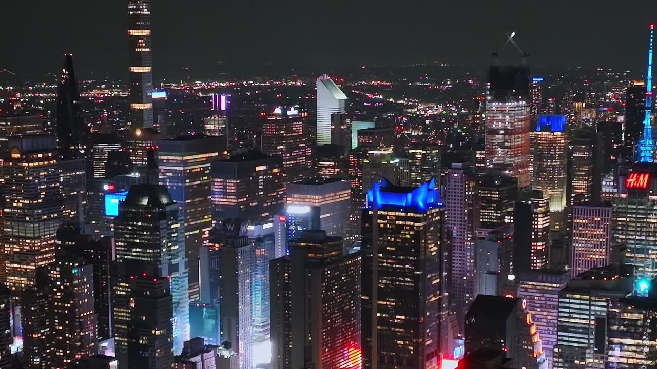 City skyline at night showcasing bright lights in New York from above