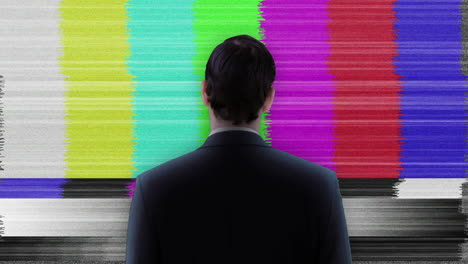 Businessman-looking-at-static-tv