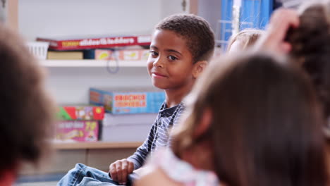 elementary schoolchildren and listening to a story in class