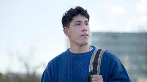 young student looking around outside university
