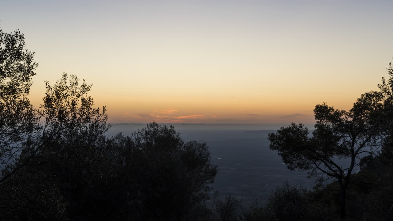 Sunset timelapse of Mallorca. Beautiful colors in sky. Villages and fields down below. Static shot.