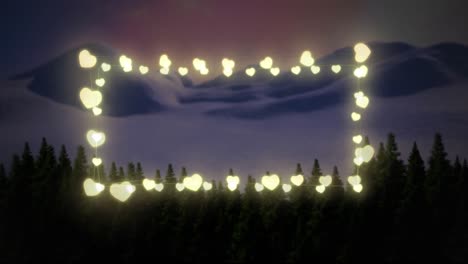 yellow heart shaped fairy lights against winter landscape with multiple trees