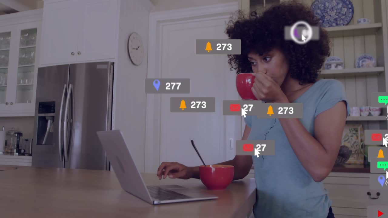Woman content creator eating cereal, typing on laptop initiating live icons for engagement