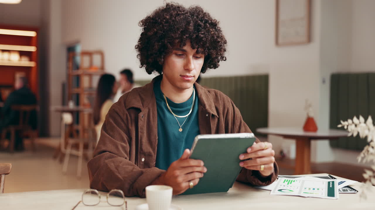 Portrait of a smiling man with curly hair in a cafe