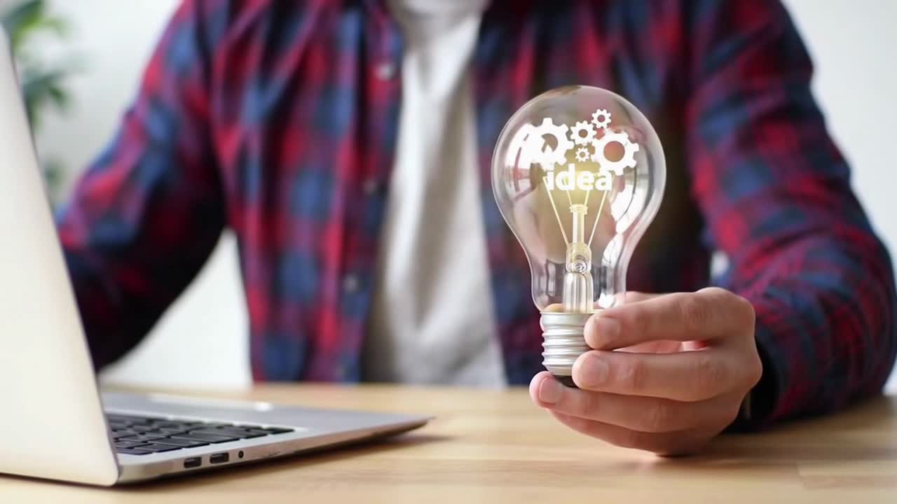 Man Holding a Glowing Lightbulb with Gears Inside Representing a New Idea