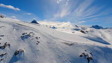 An-aerial-shot-of-a-skislope-in-a-winter-mountain-landscape-in-Les-Deux-Alpes,-France