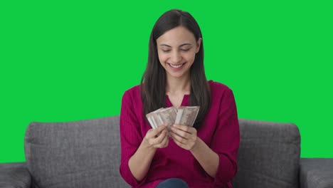 Happy-Indian-woman-counting-money-Green-screen