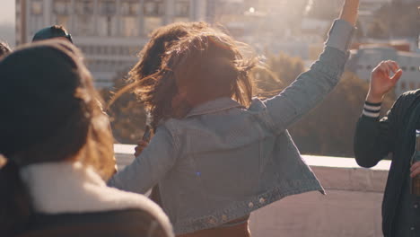 slow motion group of multiracial friends hanging out young asian woman dancing enjoying rooftop party at sunset drinking alcohol having fun on weekend celebration