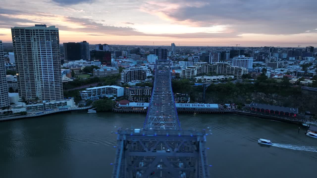 Drone shot of Story Bridge, camera orbiting Howard Smith Wharves with Story bridge in foreground