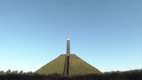 tilting from bright blue sky to austerlitz pyramid monument in the netherlands