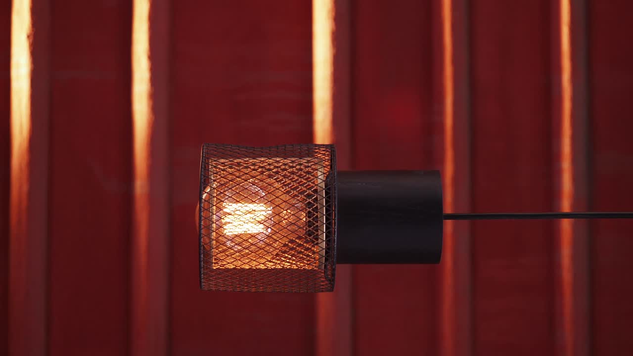 A close-up of a lamp with a red background