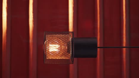 A close-up of a lamp with a red background