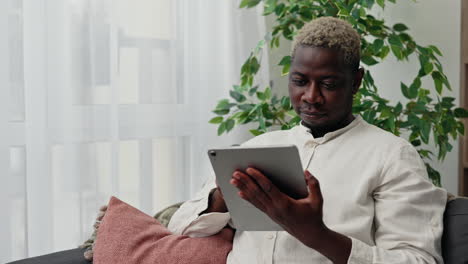 man using tablet at home