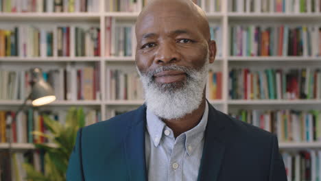 close up portrait of middle aged african american businessman with beard laughing happy enjoying successful career milestone professional mature black male wearing suit in library