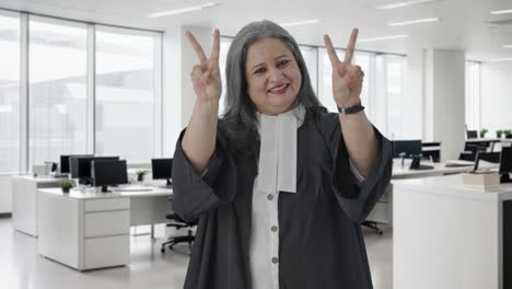 Happy-Indian-senior-female-lawyer-showing-victory-sign