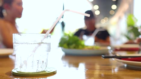 a vibrant dining scene with people enjoying vietnamese cuisine in a well-lit restaurant setting