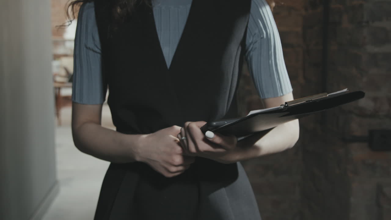 Midsection of Business Woman with Clipboard
