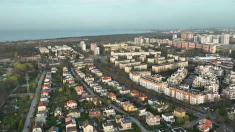 aerial flyover zabianka district of gdansk town with large low class apartment buildings and baltic sea in background