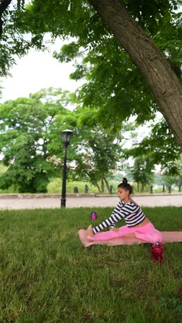 woman practicing yoga in a park