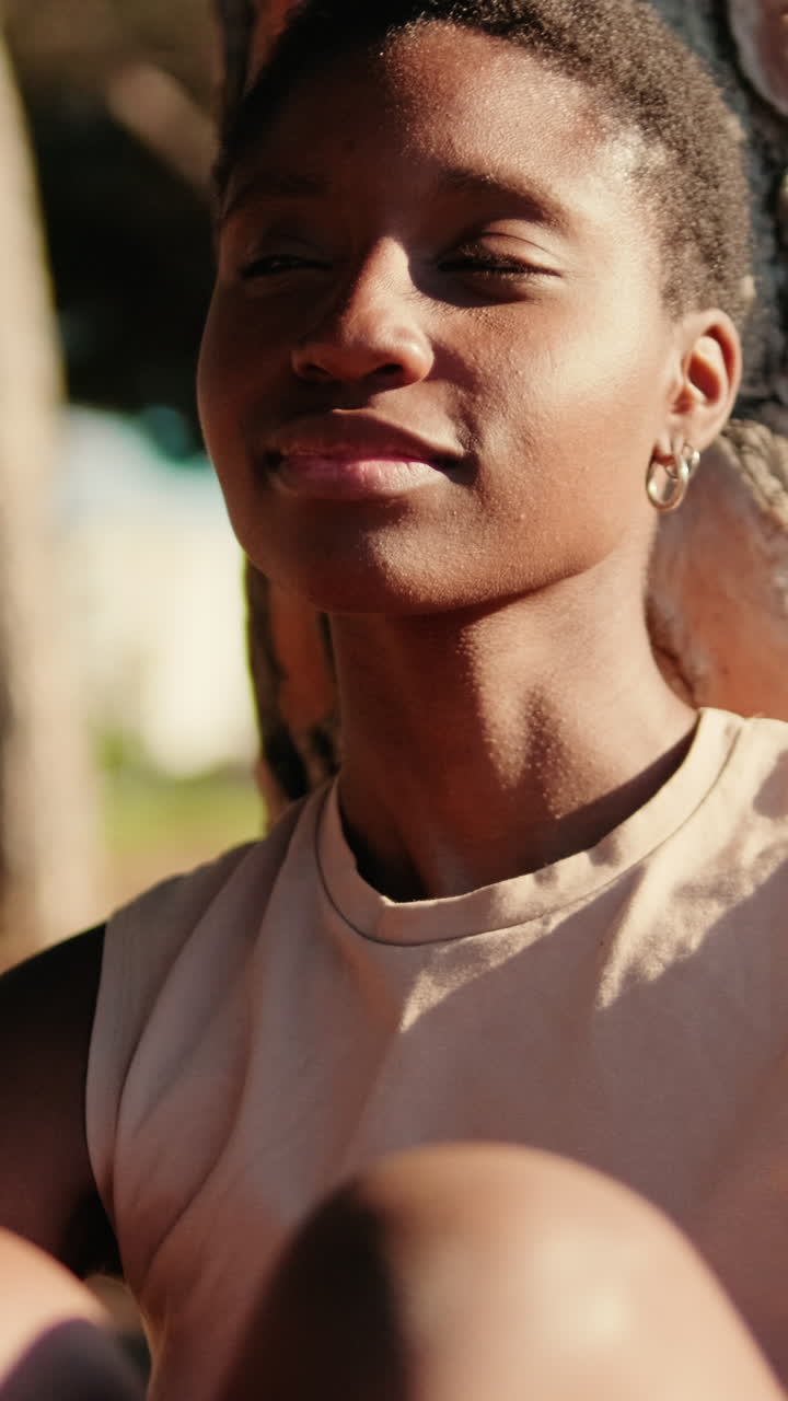 Close-up Portrait of a Serene Young Black Woman in Sunlight