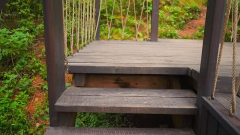 stairs pathway for travelers in glamping resort. path leading to entrance of cottage in glamping small town surrounded by forest during autumn time