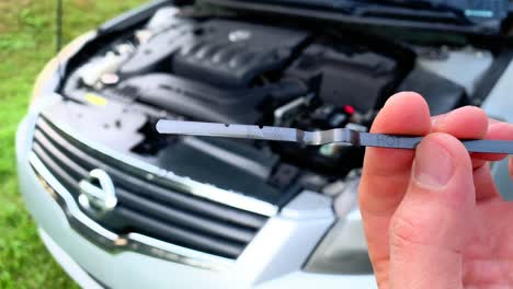 checking car dipstick motor engine oil level