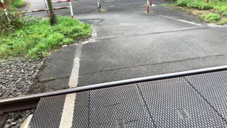 panning shot of old railroad crossing with gates