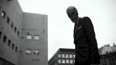 man in skull mask in city