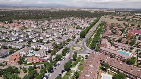 Circling-aerial-view-above-Calle-Sevillanos-cenral-road-in-Sevilla-la-Nueva-scenic-old-town-cityscape