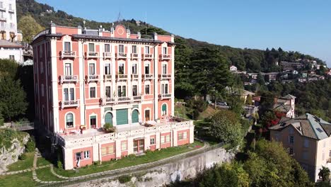 luxury vintage hotel building in brunate, italy, aerial drone view