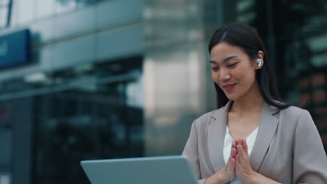 business woman having a video call outside