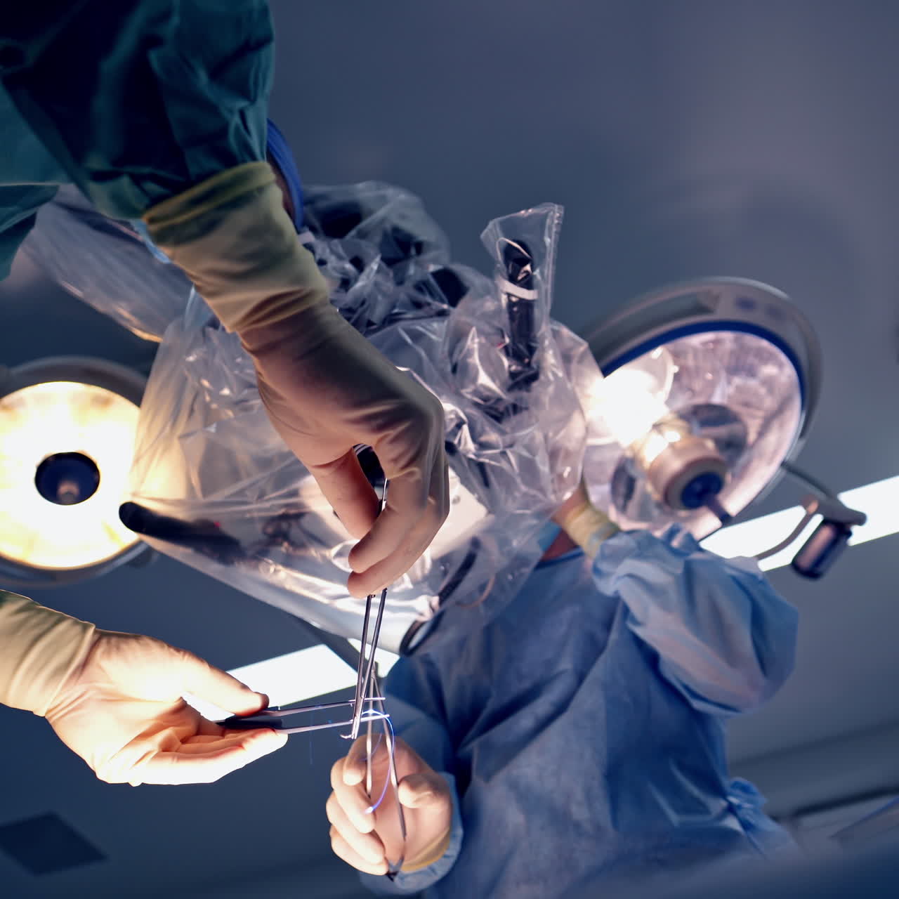 Operation through microscope. Two specialists perform an neurosurgery using new equipment in clinic.