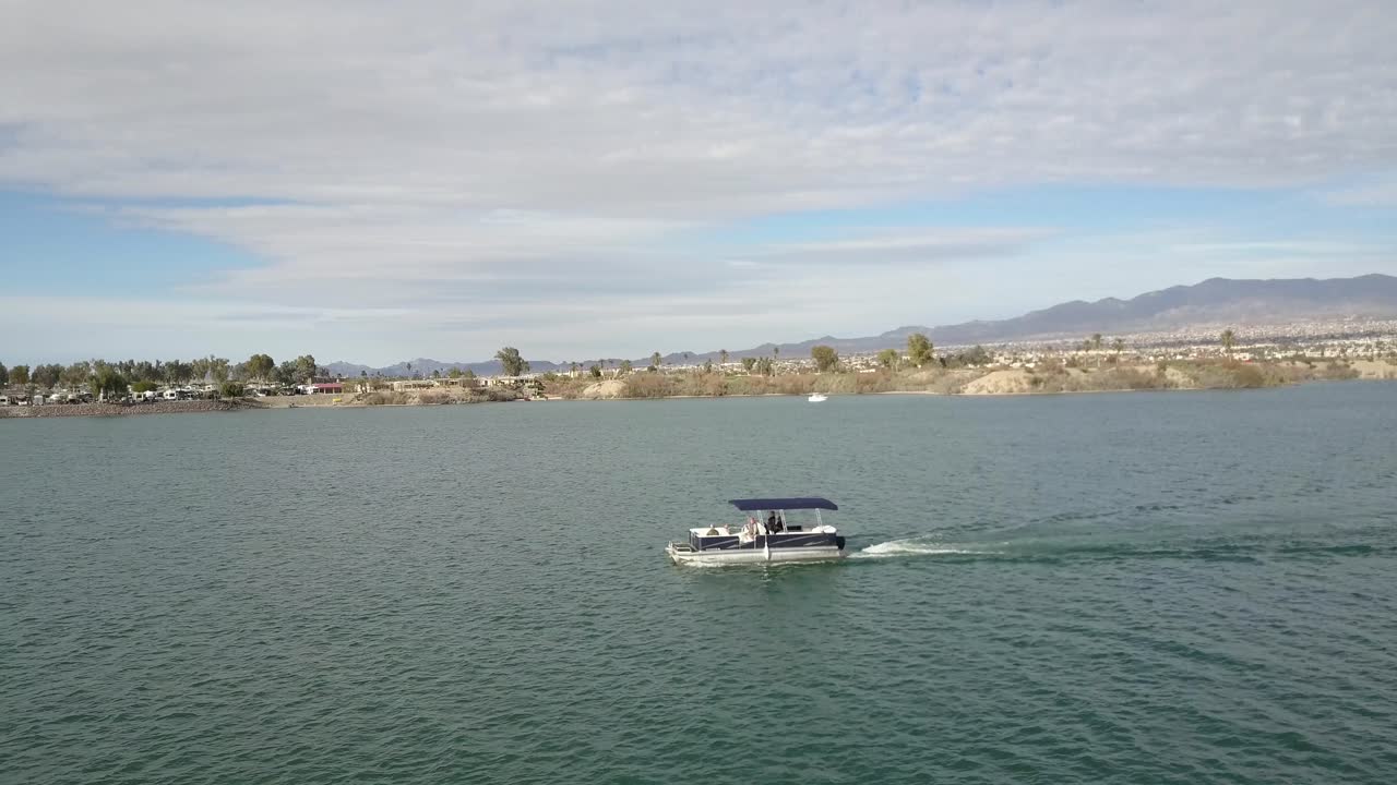 Aerial View Of Boat On Lake With Mountains 4k
