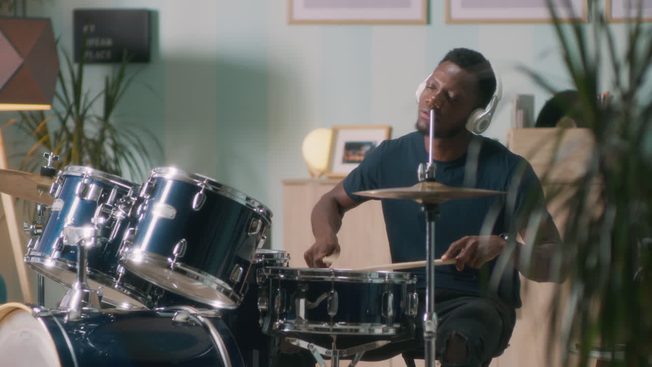 Black Musician Enjoying Drum Session African American Male Drummer Playing Drums with Closed Eyes and Enjoying Music Session in Home Studio