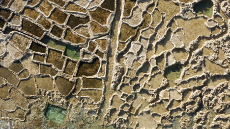 salt pans in xwejni bay on the island of gozo, malta - aerial top down