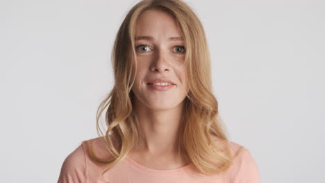 caucasian woman showing silence gesture on camera.