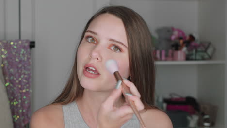 beautiful teenage girl vlogger filming makeup tutorial sharing beauty video enjoying social media influencer recording vlog at home